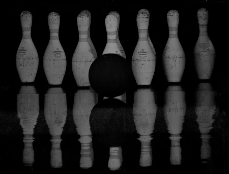 a row of bowling pins in front of some water