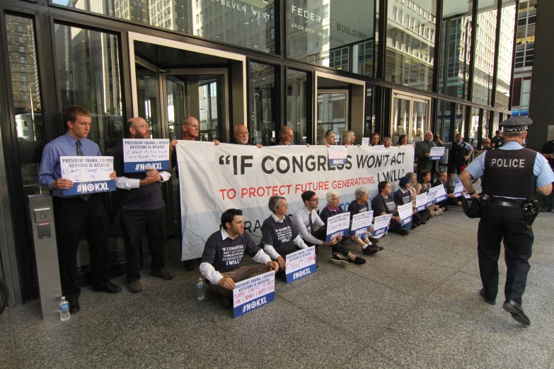 a group of men hold placards while holding signs and talking to each other