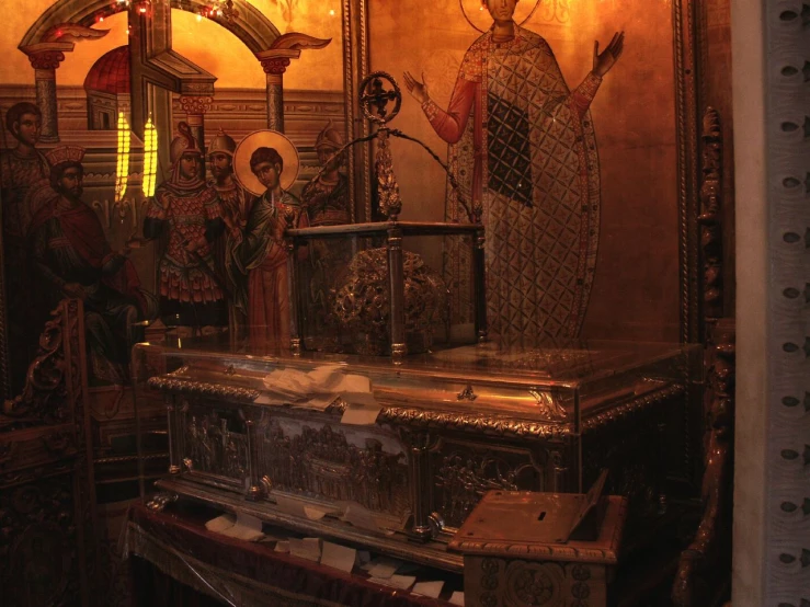 an ornate altar with a golden cross and many paintings