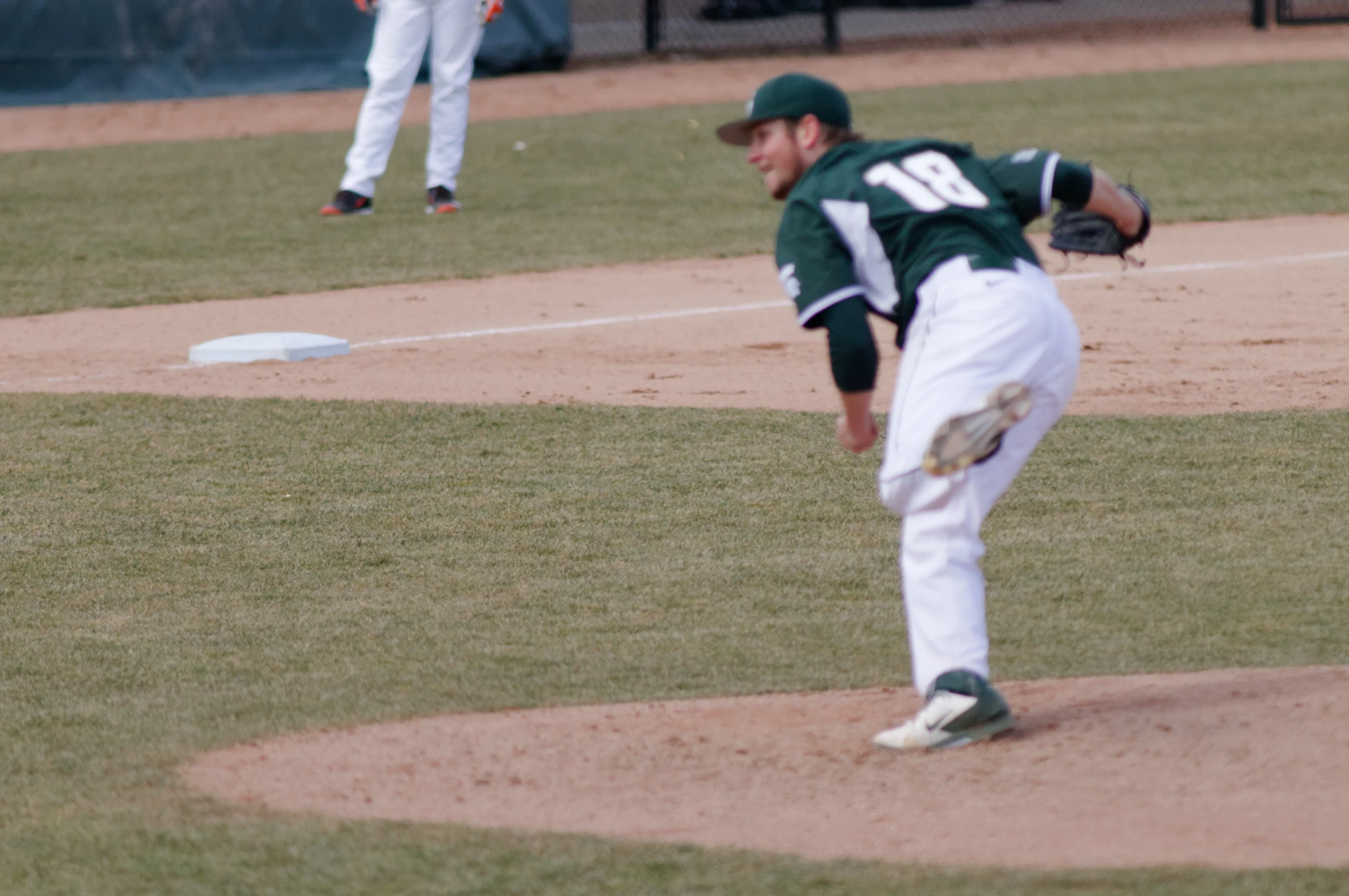 pitcher pitching the ball during a baseball game