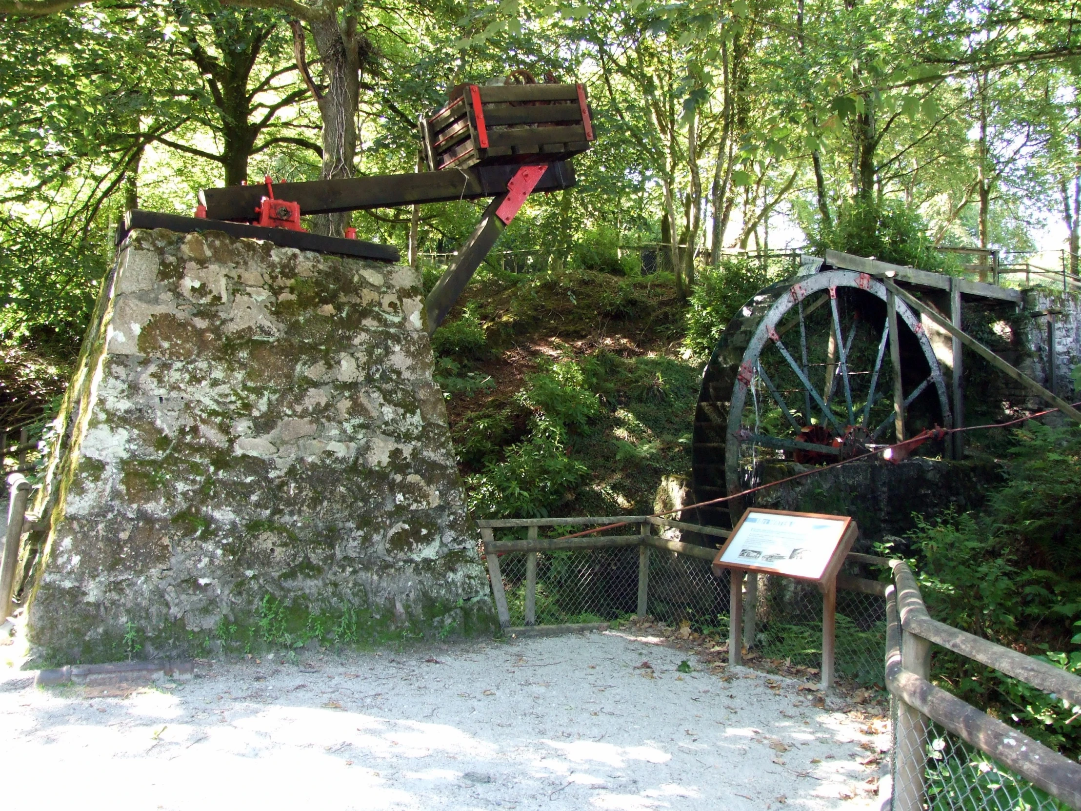 there is a waterwheel in the woods