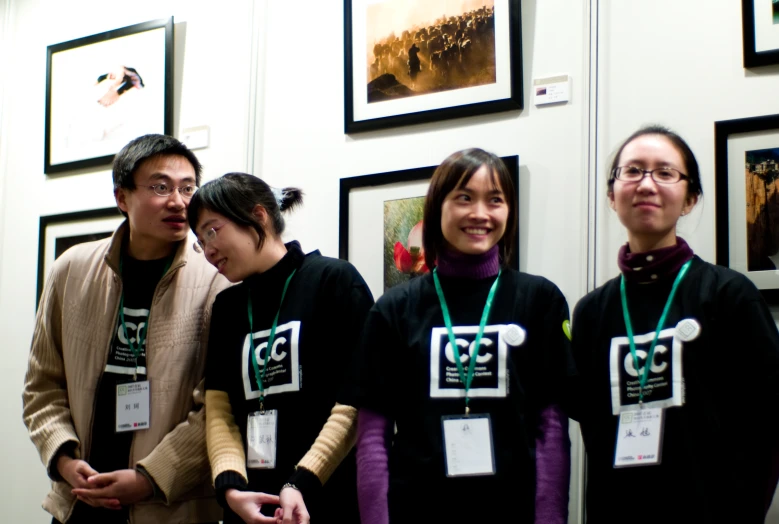 four people pose with their name tags on their sweatshirts