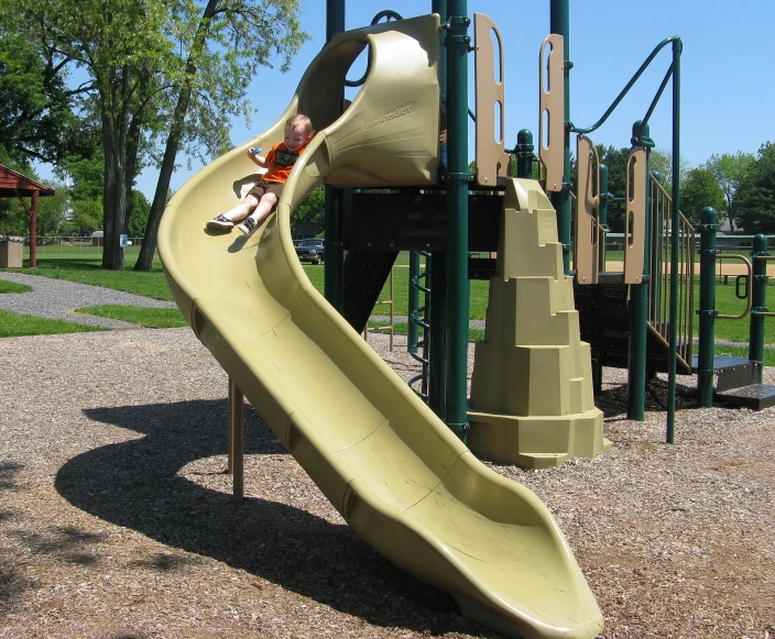 an empty play set in a park with several slides