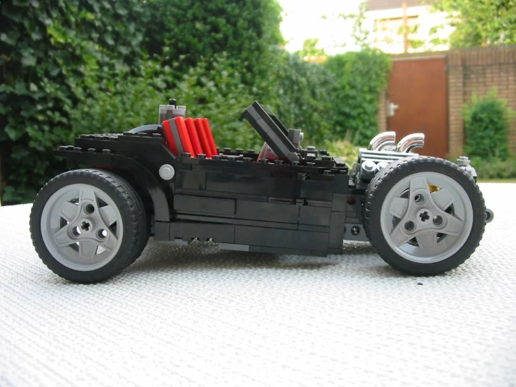 a lego vehicle is sitting on a surface