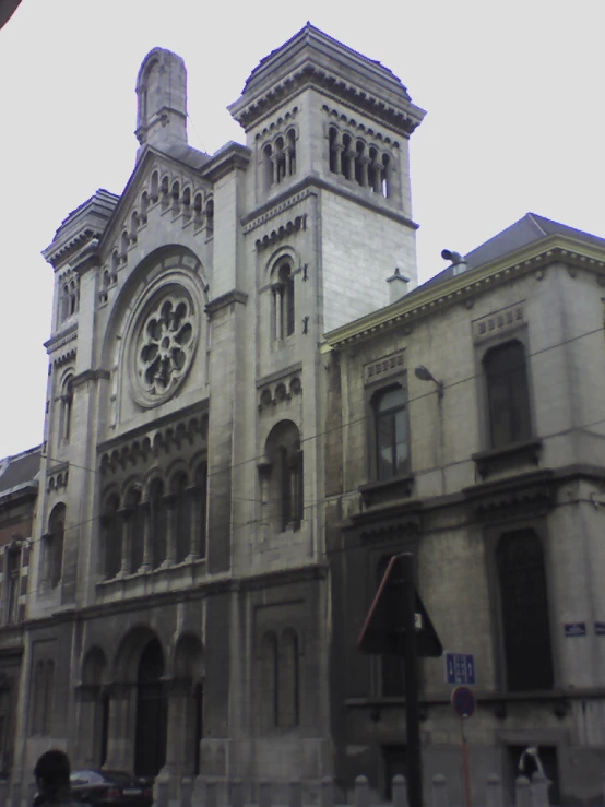 the tall building is very large with a clock on it's tower