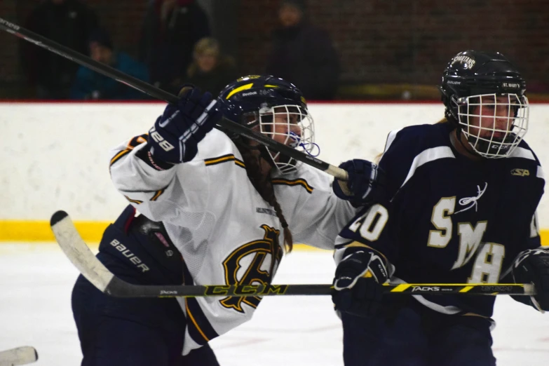 two people on the ice playing hockey