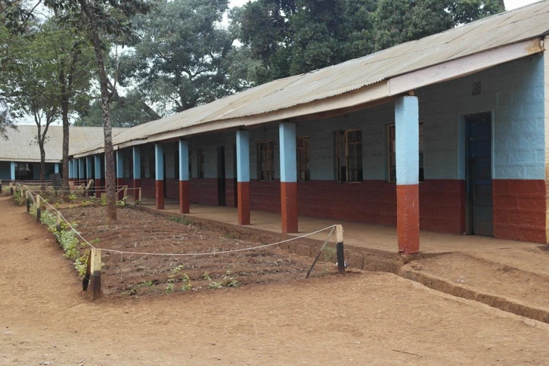 the outside view of an african school showing all its windows and doors