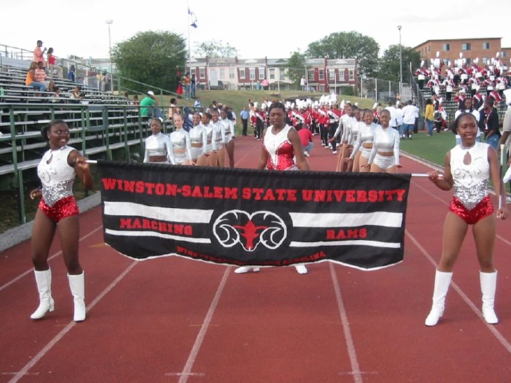 a group of cheerleaders and cheerleaders at the end of a game