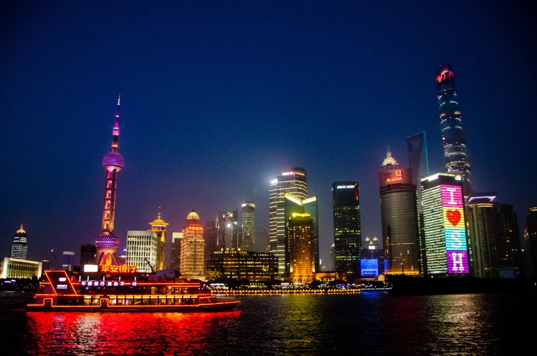 boats on the water in front of tall buildings