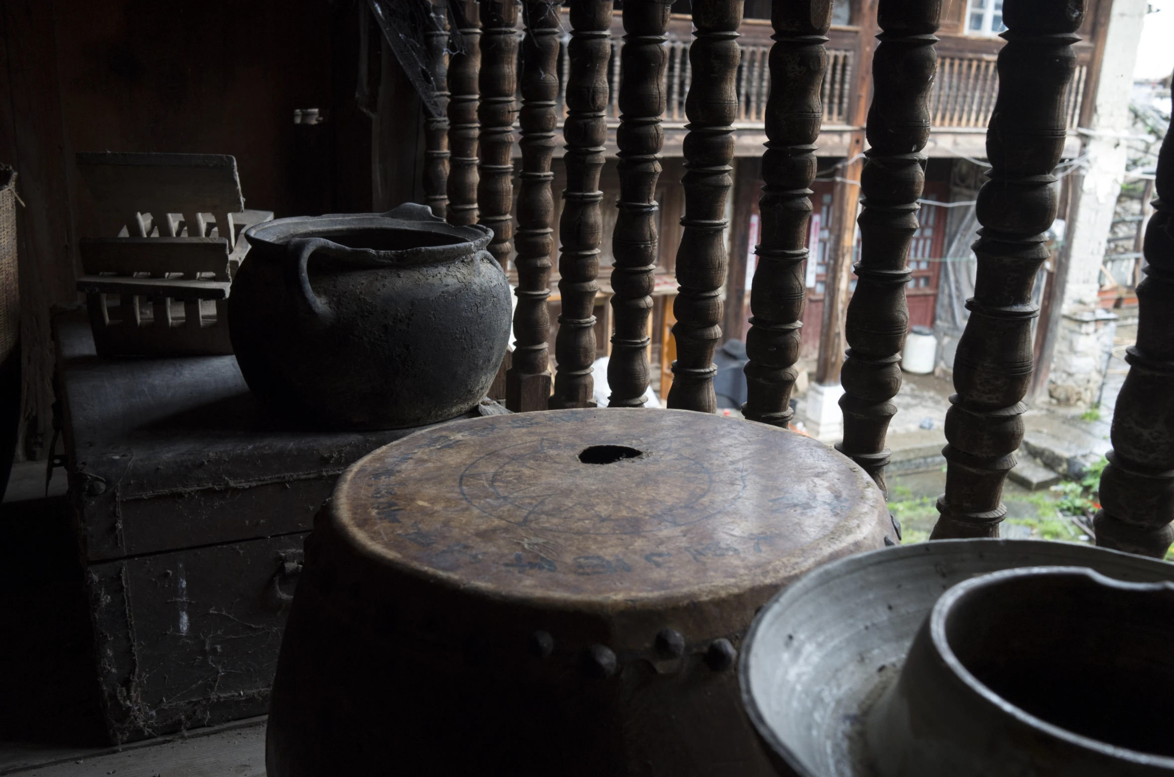 three large pots sitting on top of wooden crates