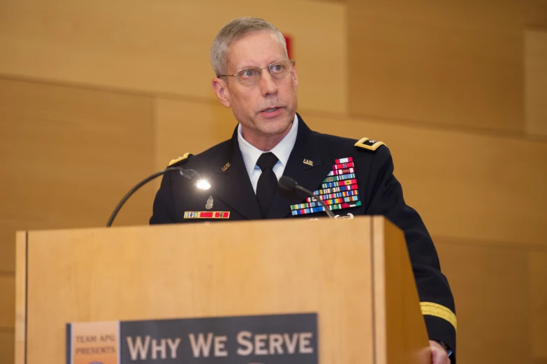 a man in a military uniform stands at a podium