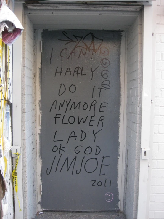 a graffiti on the side of a door with writing on it