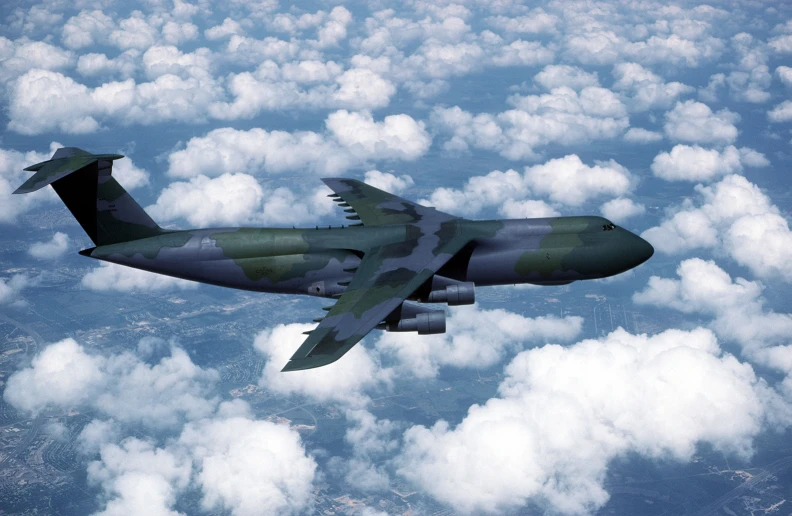 an air force plane flying above the clouds