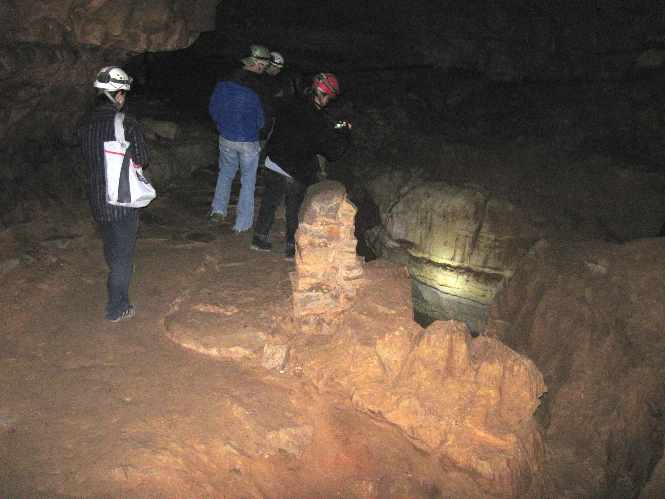 a group of people standing on the side of a cliff