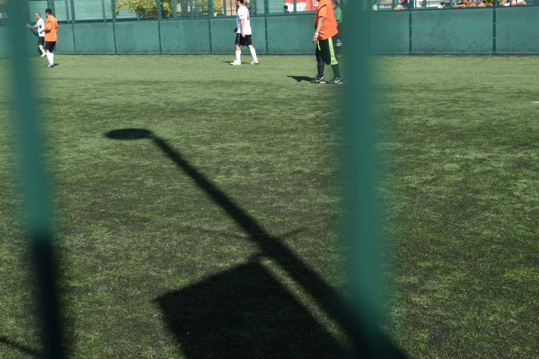 boys playing soccer in a field with the sun shining on them