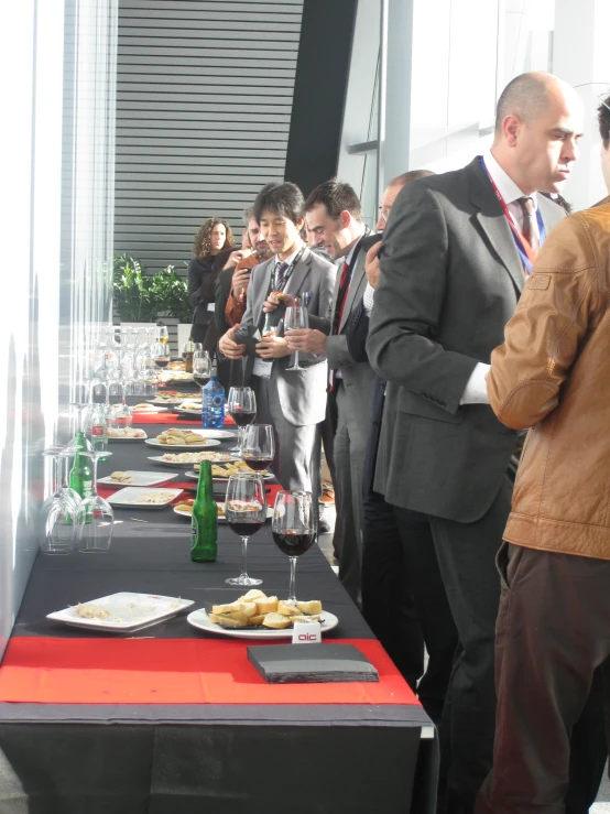 a group of people stand at a buffet table