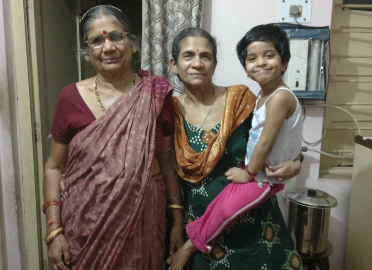 three ladies are standing next to each other