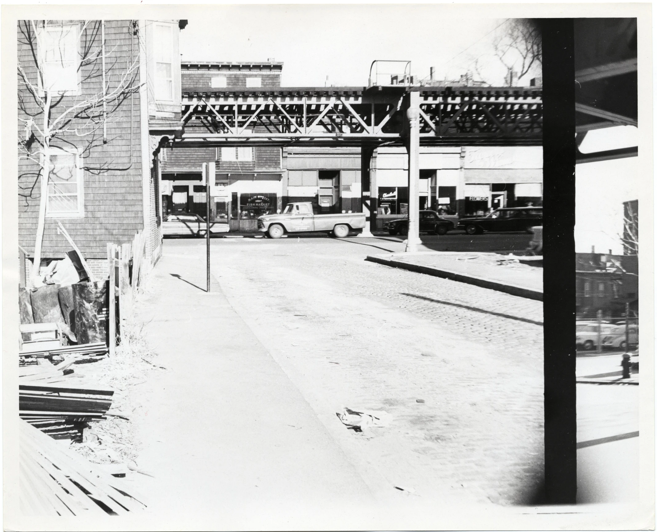 black and white pograph of old street near bridge