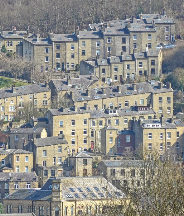 a city with tall brick houses nestled near many trees