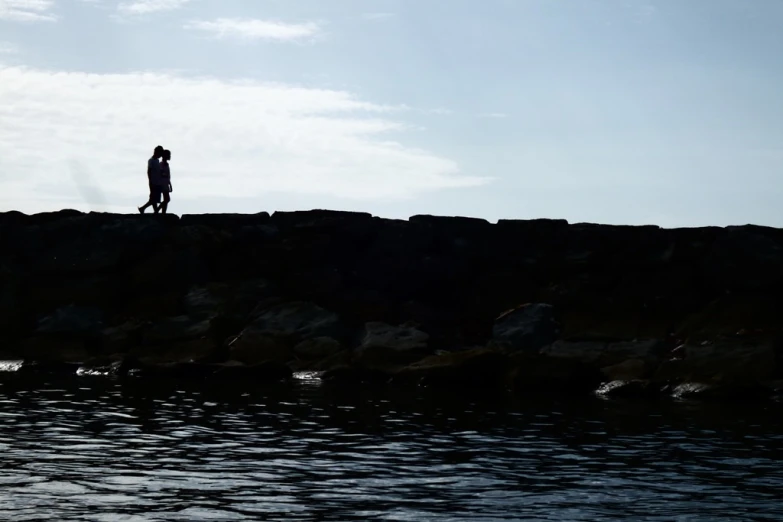 a man standing on the edge of the ocean