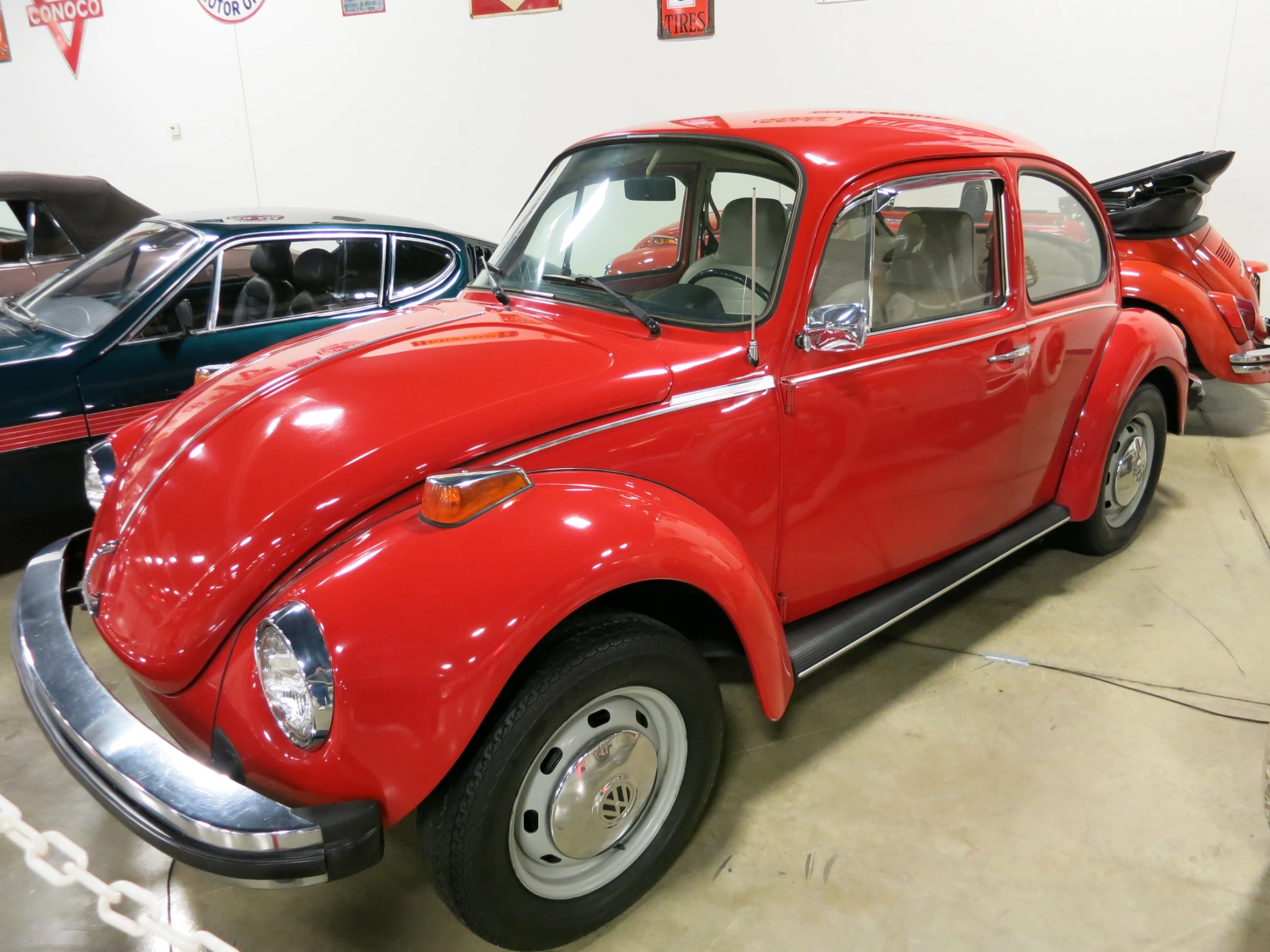 some red classic cars and people in a car show