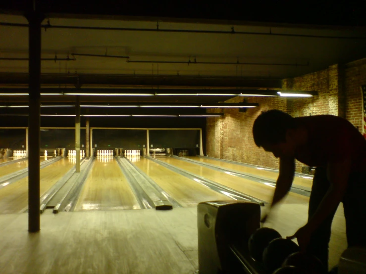 a man in bowling alley with a skateboard