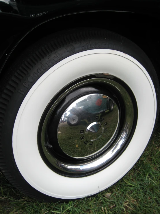 a reflection of a car's tire, with its rim missing