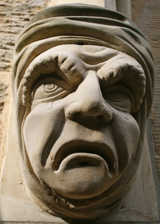 the face is sculpted into the front of a building