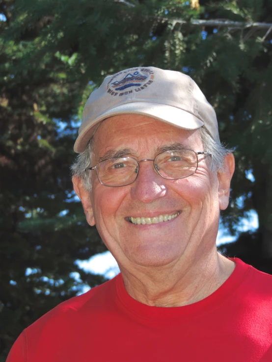 an old man with glasses and a red shirt