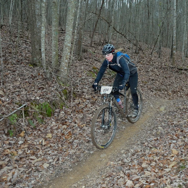 the man is riding his bike down the path