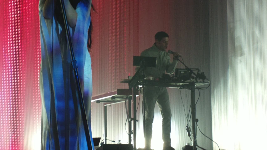 a dj is using the keyboard on stage