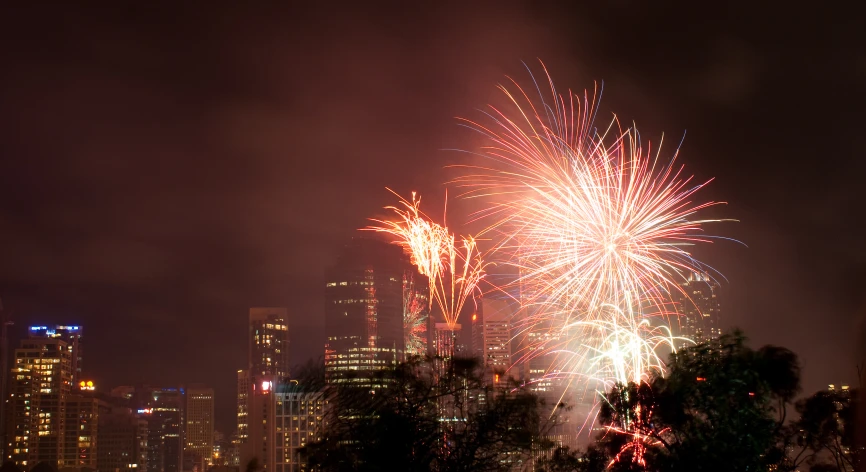 colorful fireworks exploding above city skyline at night