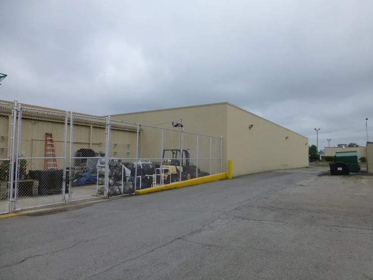 an empty parking lot with a chain linked fence