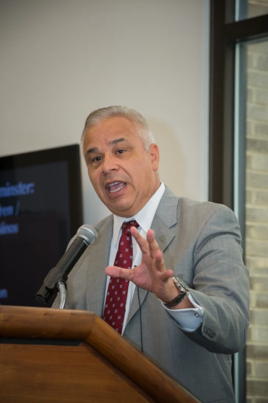 man giving a speech with hands out