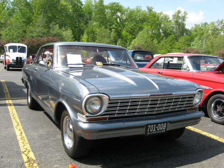 an older car sits parked in a lot