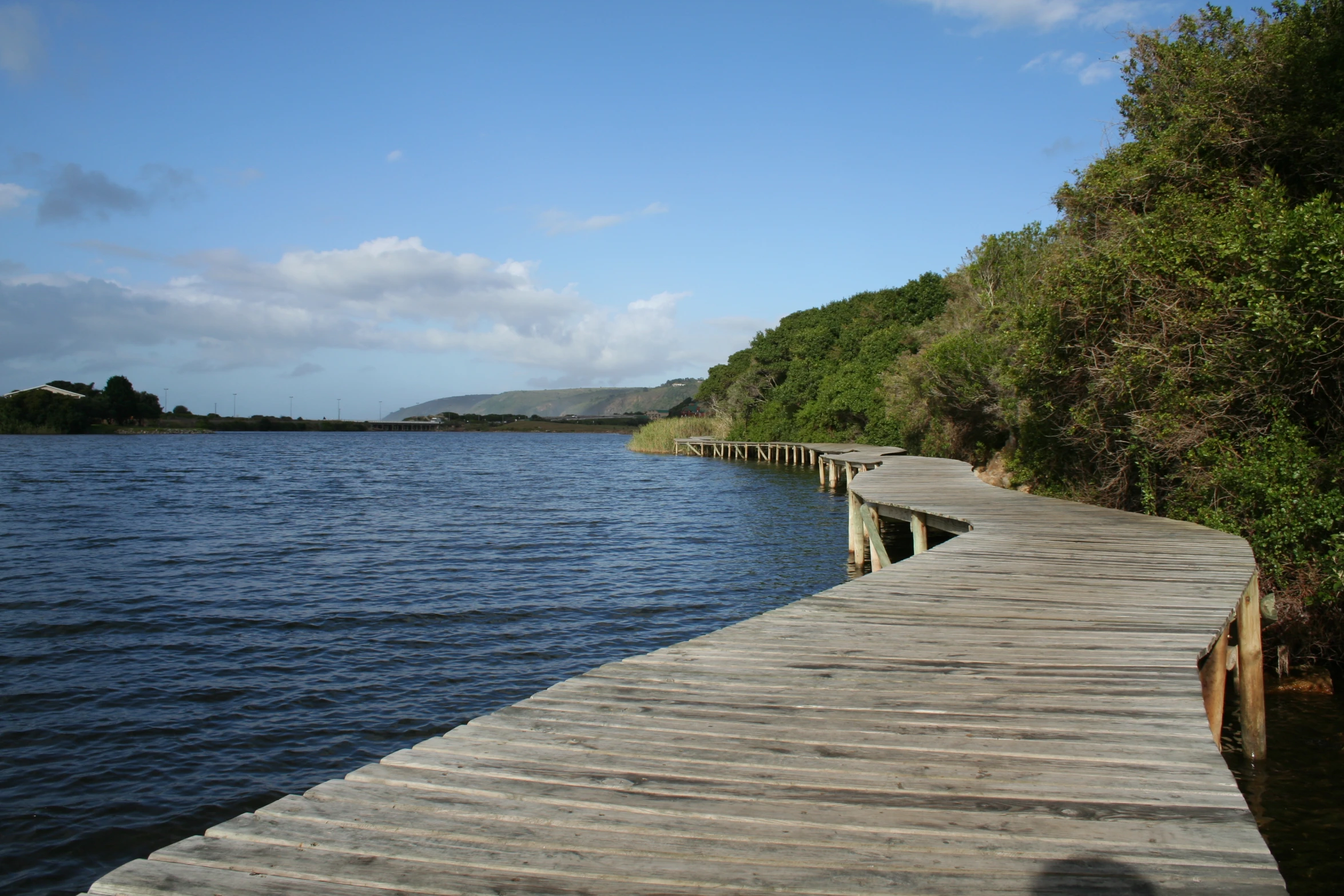 a long wooden bridge over the water