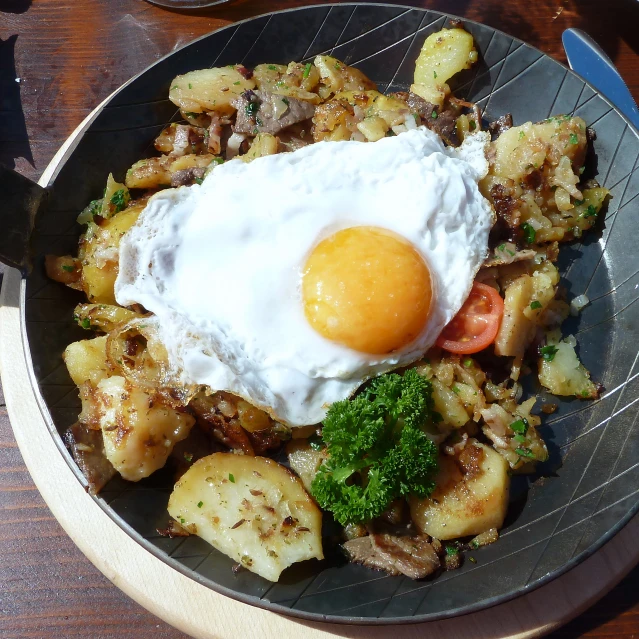 the plate is full of food with a fried egg on top