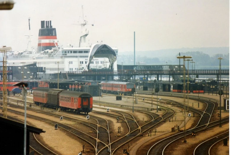 cargo trains passing near a large ship