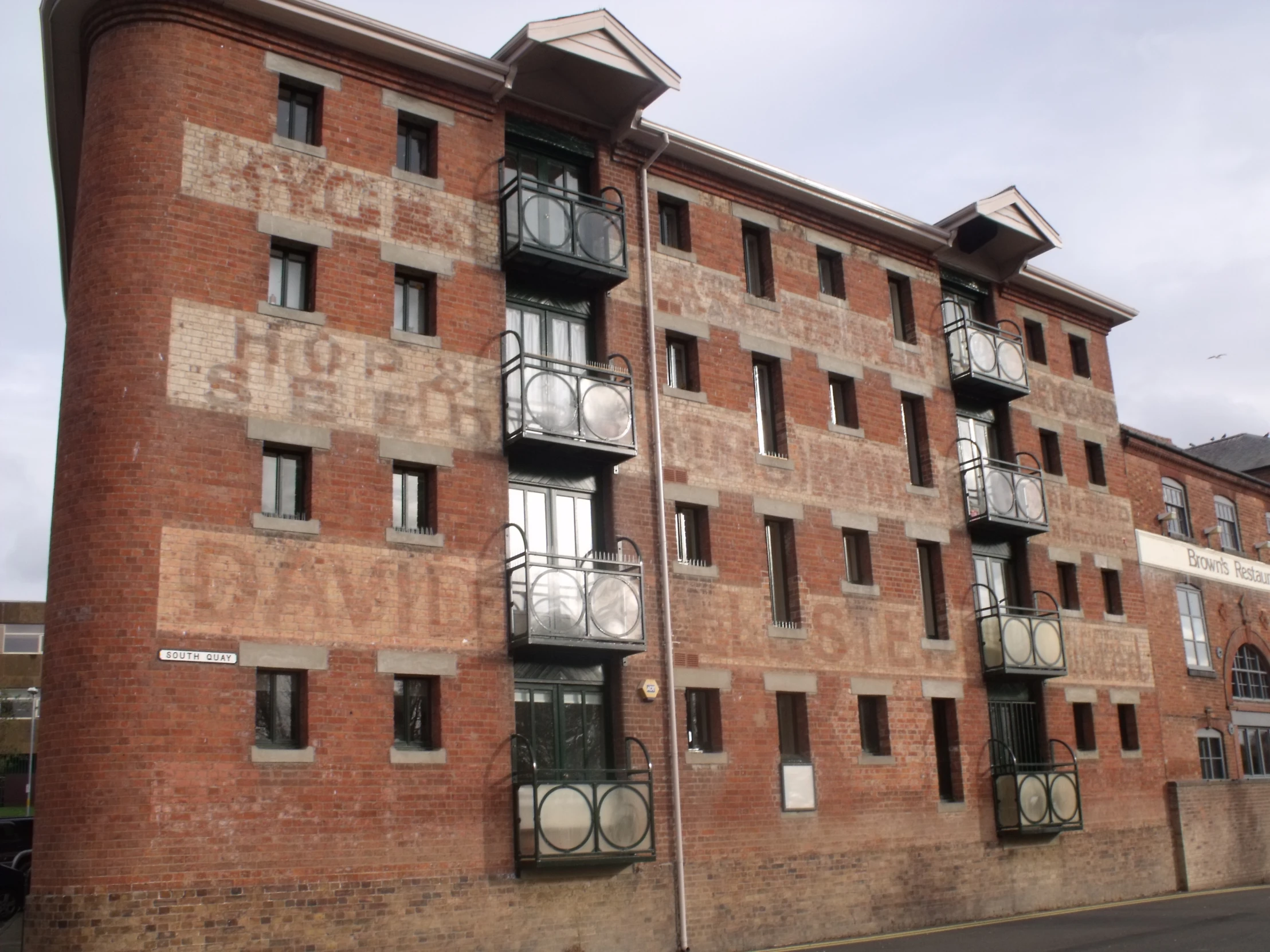 two tall brown brick buildings that have windows