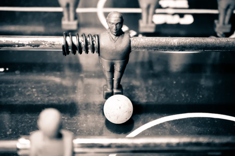 an image of figurines next to a ball on a conveyor belt