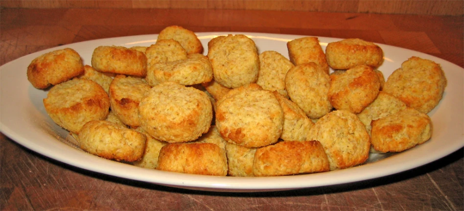 several small biscuits sitting on top of a white plate