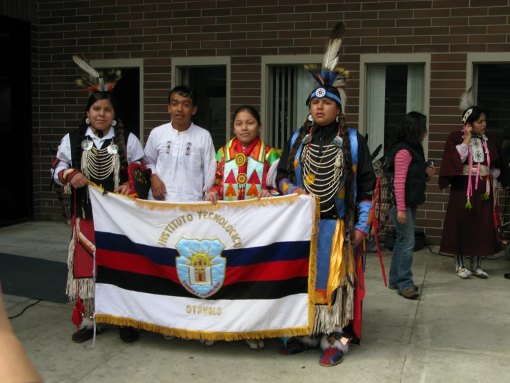 several people standing with a flag next to them