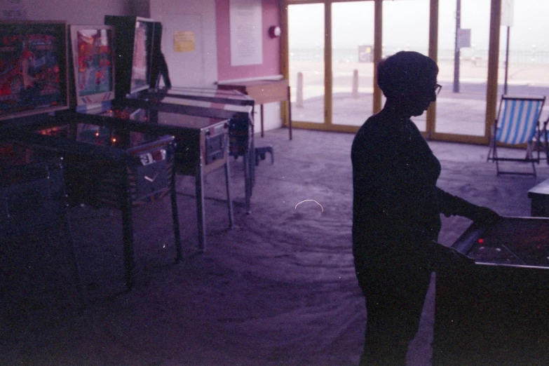 a man plays a video game in a dark room