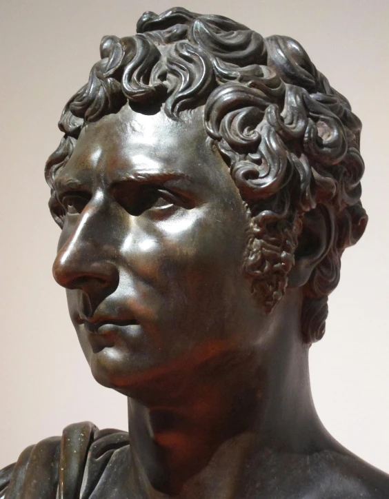 an image of a bronze sculpture with curls in the hair