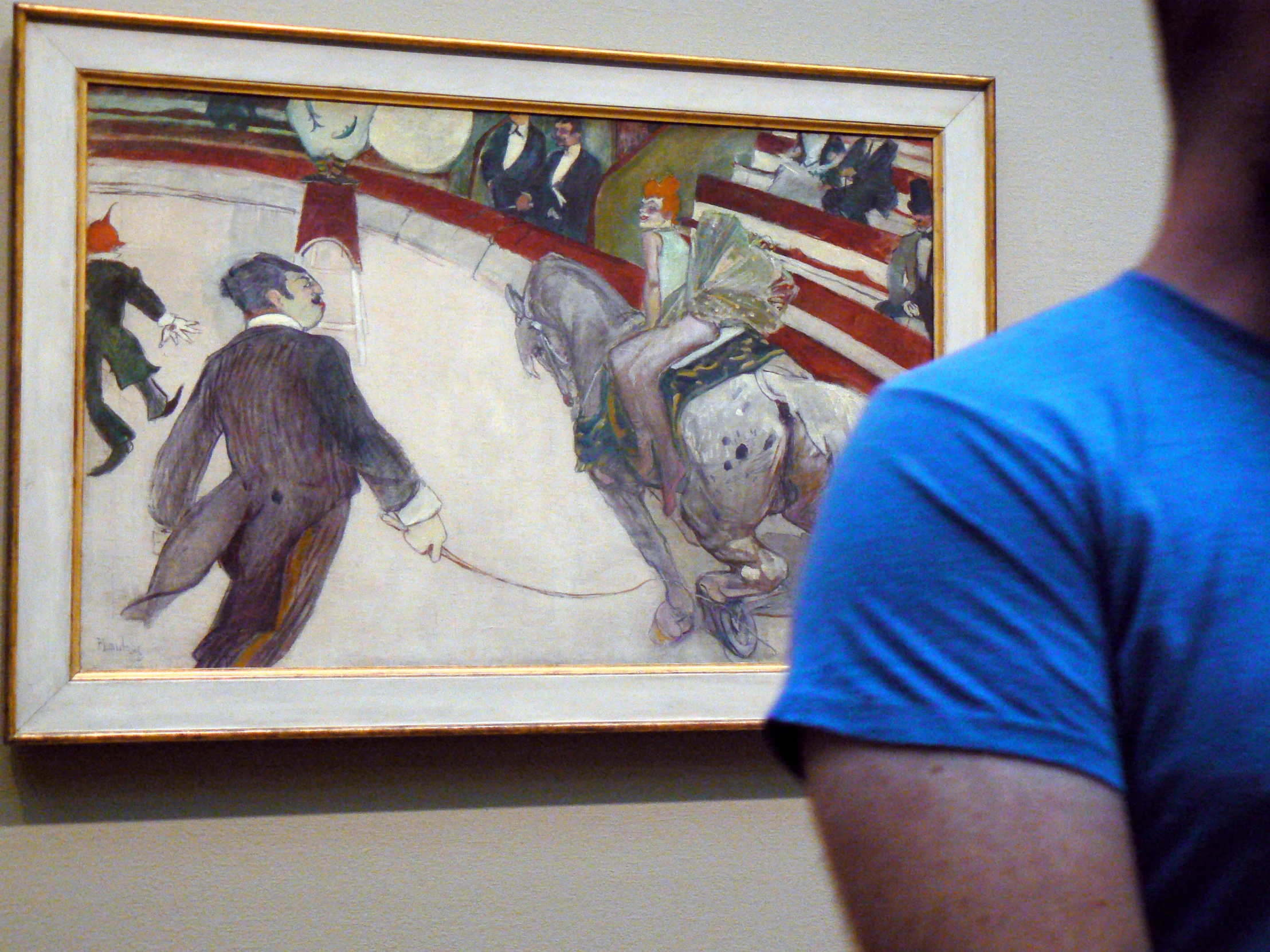 a man that is looking at a painting