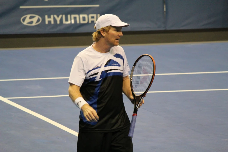 a tennis player standing on the court with his racquet