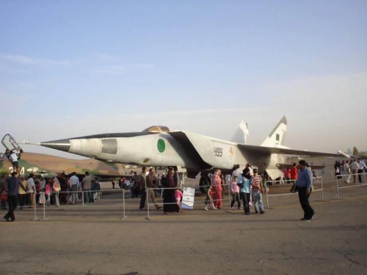 people are standing on the tarmac of an airport