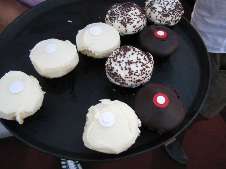 chocolates covered in white frosting and sprinkled with chocolate