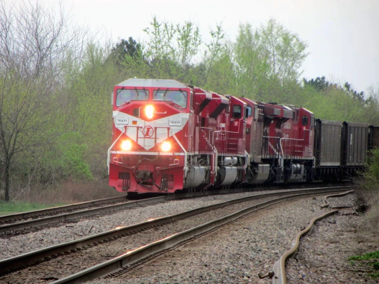 a train is on the track with its lights on