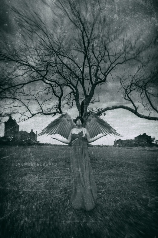 the woman is walking in a field and her wings are spread out